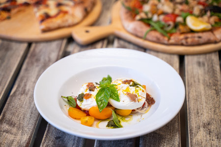 Burratta Cheese and cherry tomatoes with pesto sauce,Coasta Italian Foodの写真素材