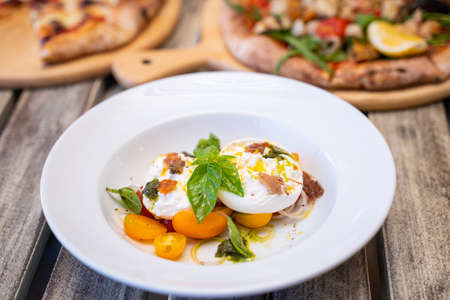 Burratta Cheese and cherry tomatoes with pesto sauce,Coasta Italian Foodの写真素材