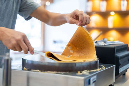 cooking chocolate crepes with crepe maker,crepeの写真素材