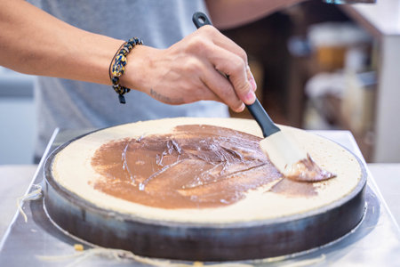 cooking chocolate crepes with crepe maker,crepeの写真素材