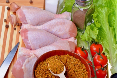 Fresh chicken legs on cutting boardの写真素材