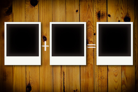 Photo frames on wooden board background texture