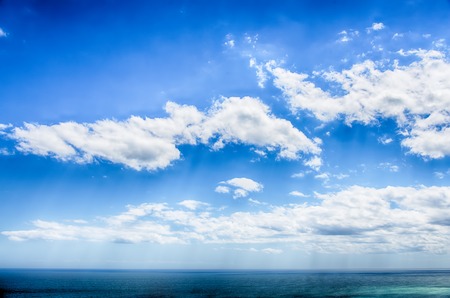Blue sky with cloud and ocean closeup. HDR imageの写真素材
