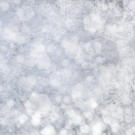 Frost patterns on window. Festive bokeh background