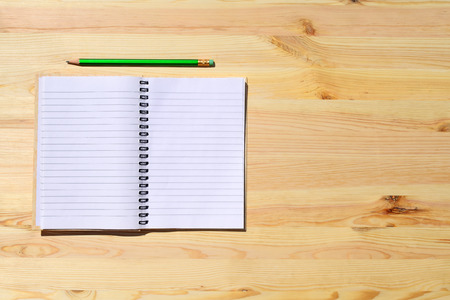 Workplace and tools of a carpenter or builder-open notebook and pencil lie on the working surfaceの写真素材
