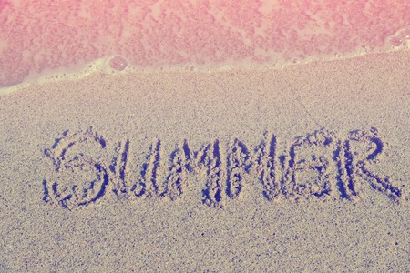 Word Summer on beach sand.Special toned photo in retro styleの写真素材