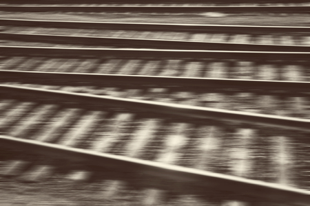 The concept of the speed and movement. Railroad tracks in motion blur. Photo toned in vintage styleの写真素材