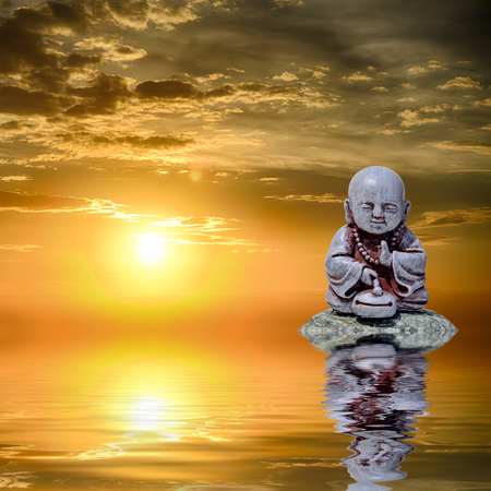 Feng Shui background. Buddha reflected in water at sunriseの写真素材