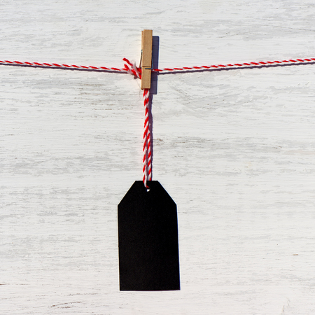 Blank black price tag on the background of white wooden planksの写真素材