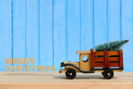 Christmas background.Toy truck carries gifts and a Christmas treeの写真素材