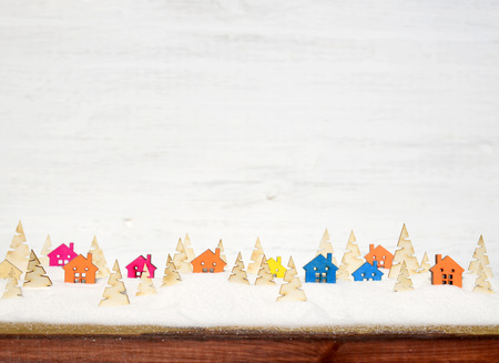 Christmas composition with small wooden houses, Christmas trees and snow.の写真素材
