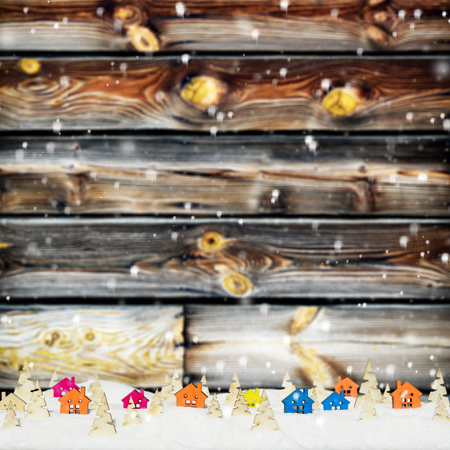 Christmas background with small wooden houses, Christmas trees and snowの写真素材