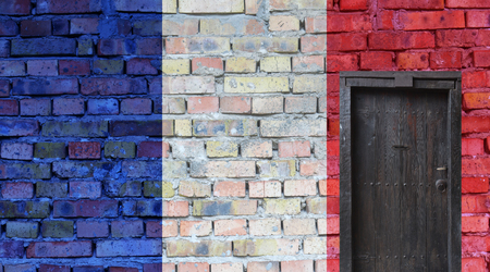 French flag painted on an old brick wall. Closed door in a wallの写真素材
