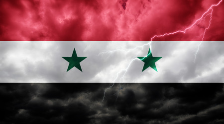 Syrian flag against dark sky, clouds and lightningの写真素材