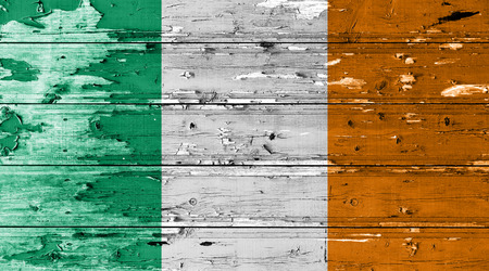 Ireland flag on wood texture background with old paint peelsの写真素材