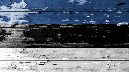 Estonia flag on wood texture background with old paint peelsの写真素材