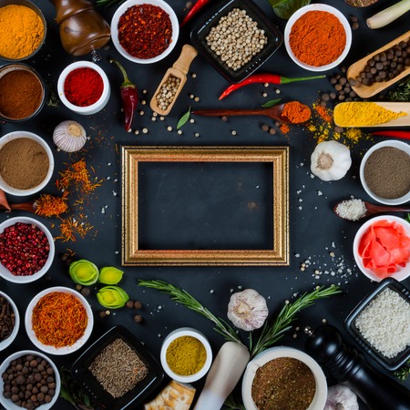 Large set of spices, herbs, vegetables and wooden photo frame on black backgroundの写真素材