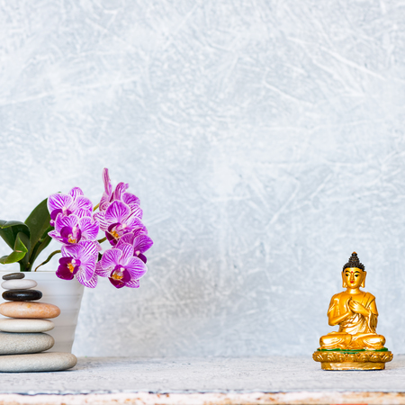 Buddha, pyramid of pebbles and orchid flower as zen backgroundの写真素材