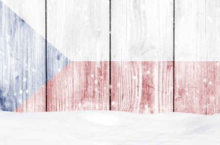 Czech Republic flag as Christmas background with white wooden wall, falling snow and snowdriftの写真素材