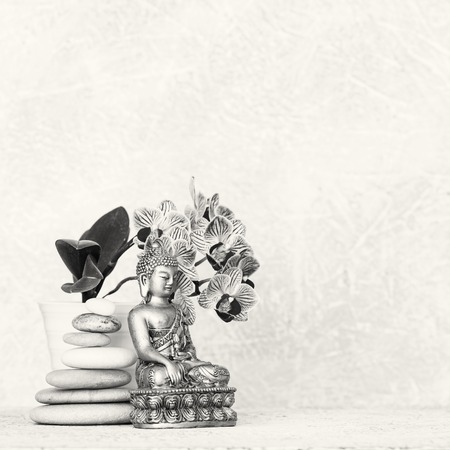 Buddha, pyramid of pebbles and orchid flower black and white zen backgroundの写真素材