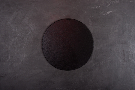 Black background with black round stone tray for product presentationの写真素材