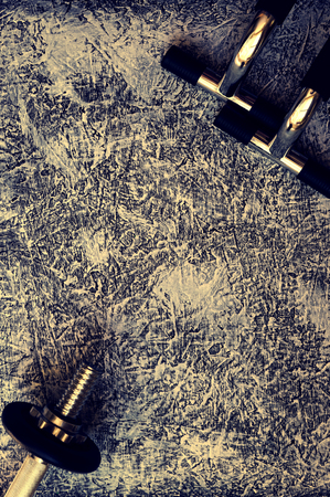 Dumbbells and push up bars. Fitness equipment black and white background. Photo in vintage styleの写真素材