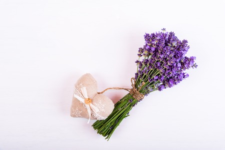 Lavender flowers and heart on a white wooden backgroundの写真素材