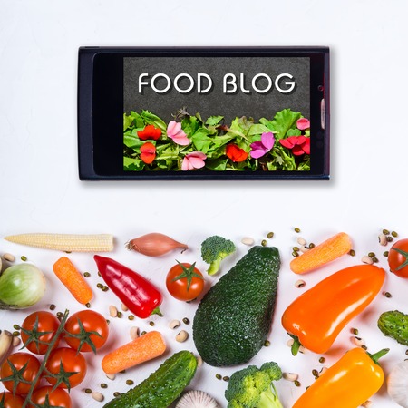 Food blog concept. Big set of vegetables, spices and smartphone on a white backgroundの写真素材