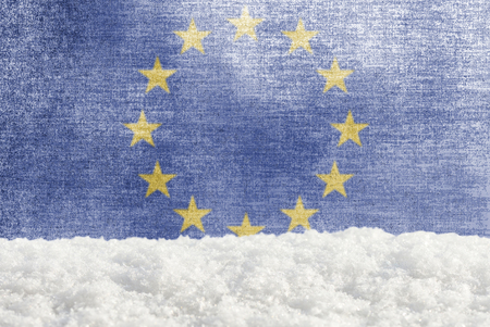 Winter grunge background with snowdrift and European union flag in the backdropの写真素材