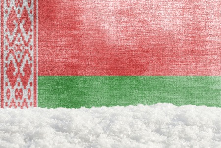 Winter grunge background with snowdrift and Belarusian flag in the backdropの写真素材