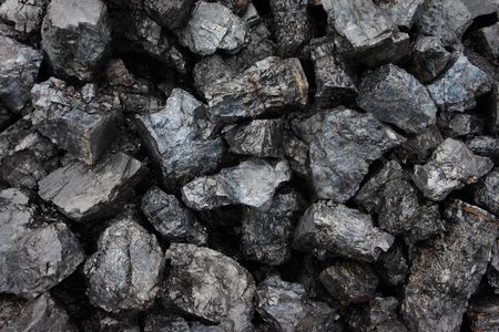  	Coal mining in Borneo awaiting shipment to the factory
