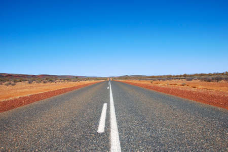 Long straight road through outback wasteland, Northern Territory, Australia