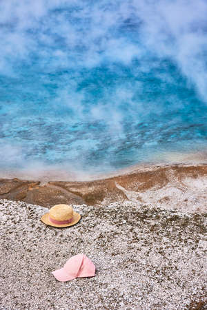 Excelsior Geyser with lost straw hat and base cap in Yellowstone Parkの写真素材