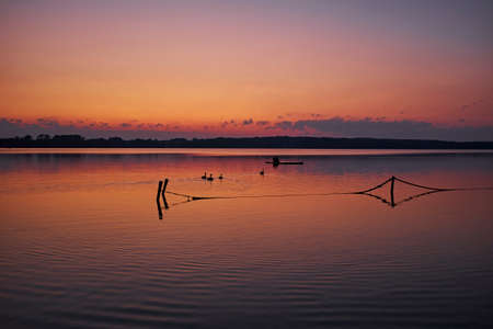 Calm lake in evening light after sunset in Northern Germanyの写真素材