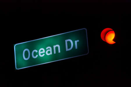 Ocean Drive Street Sign Miami Beach at Night with red traffic lightの写真素材