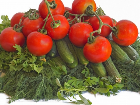 Tomatoes, cucumbers, dill leaves and parsley on the white background.の写真素材