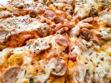 homemade pizza with simple toppings, mozzarella and sausage on a wooden trayの写真素材
