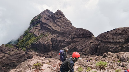 Kalibaru,Indonesia. March,2023 : 2 climber with view of the top of the mountain with amazing rocks