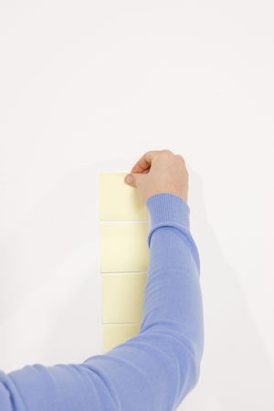 woman finishing column of reminder notes 
