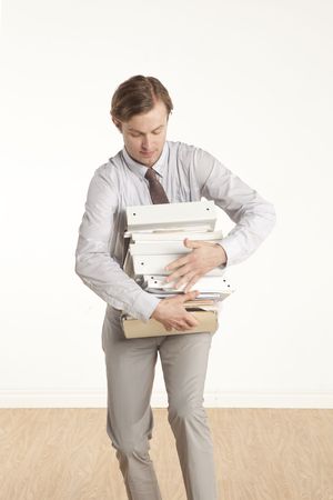young professional holding stack of work の写真素材