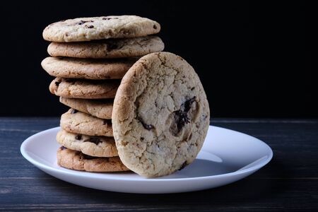 American chocolate chip cookies. Cookies, a glass of milk and a linen towel. Rustic still life.の写真素材