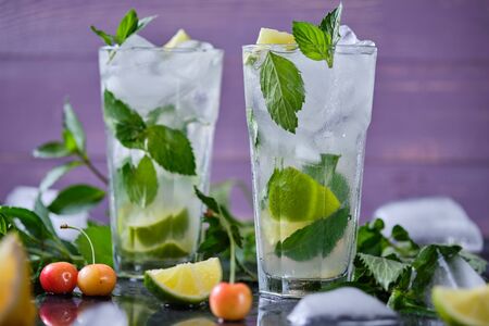 Mojito refreshing summer cocktail. Ingredients: ice, soda, rum, sugar syrup, lime, mint.の写真素材
