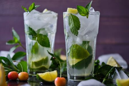 Mojito refreshing summer cocktail. Ingredients: ice, soda, rum, sugar syrup, lime, mint.の写真素材
