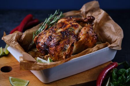 Chicken baked in the oven with spices, lemon, herbs and young potatoes.の写真素材