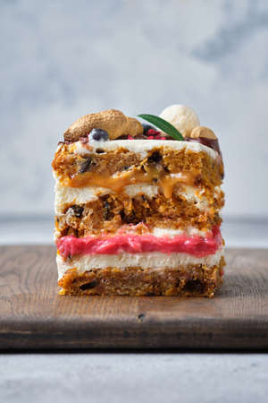 Gorgeous spicy carrot cake with two fillings: caramel and cranberry kurd. Sponge cake with nuts and spices and cream cheese cream.の写真素材