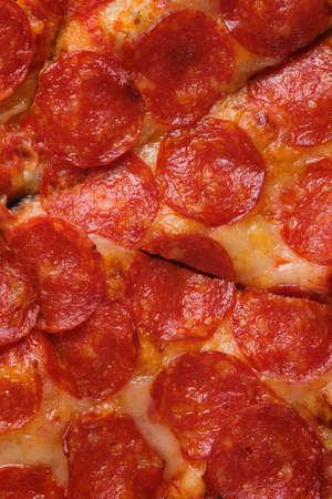 A closeup of a pepperoni pizza. Pizza with spicy sausage, tomato sauce and mozzarella cheese.の写真素材