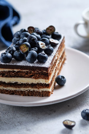 Morning breakfast with coffee and cake. Piece of cake on a plate decorated with fresh blueberriesの写真素材