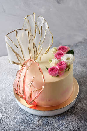 Beautiful wedding cake with delicate roses.の写真素材