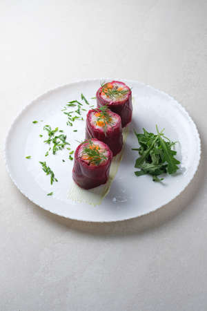 Menu for the restaurant: salad of herring, beetroot and vegetables, served in the form of rolls.の写真素材