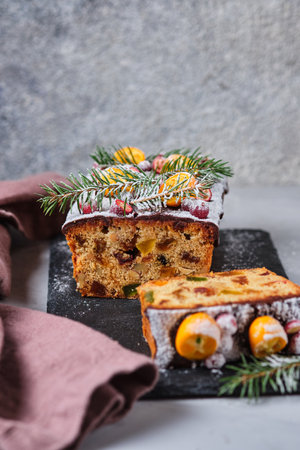 New Year's gingerbread cake with kumquat, dried berries and fruits. A festive dessert decorated with spruce twigs and fresh berries and fruits.の写真素材